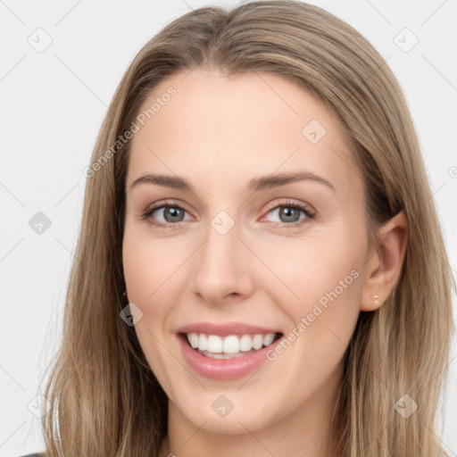 Joyful white young-adult female with long  brown hair and grey eyes