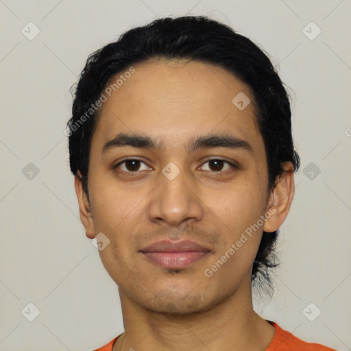 Joyful latino young-adult male with short  black hair and brown eyes