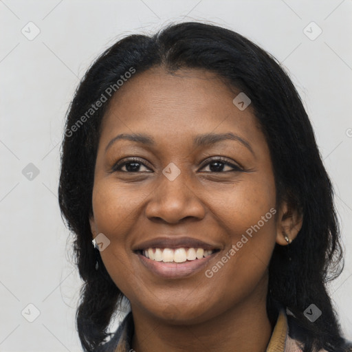 Joyful black young-adult female with long  brown hair and brown eyes