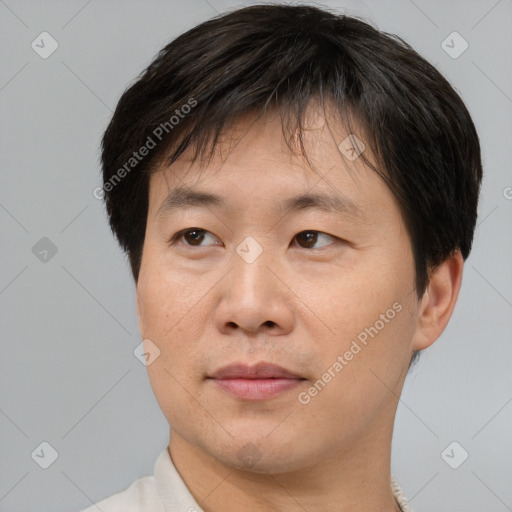 Joyful asian adult male with short  brown hair and brown eyes