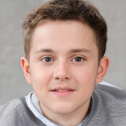 Joyful white child male with short  brown hair and brown eyes