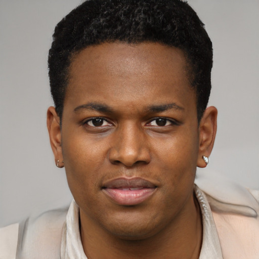 Joyful black young-adult male with short  black hair and brown eyes