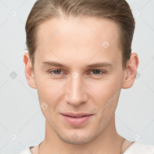 Joyful white young-adult male with short  brown hair and grey eyes