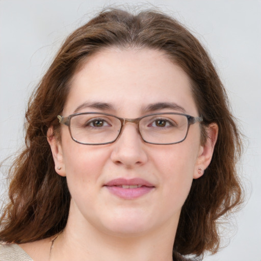 Joyful white adult female with medium  brown hair and green eyes