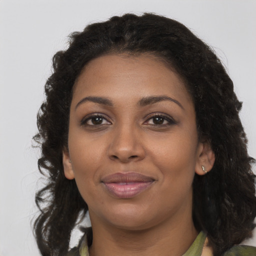 Joyful black young-adult female with medium  brown hair and brown eyes