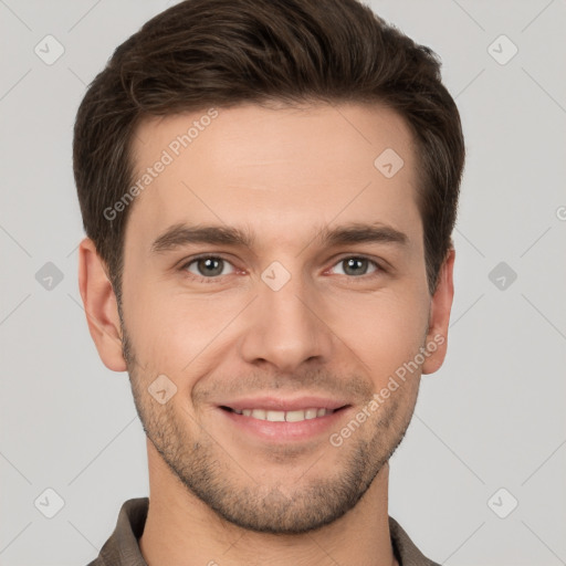 Joyful white young-adult male with short  brown hair and grey eyes