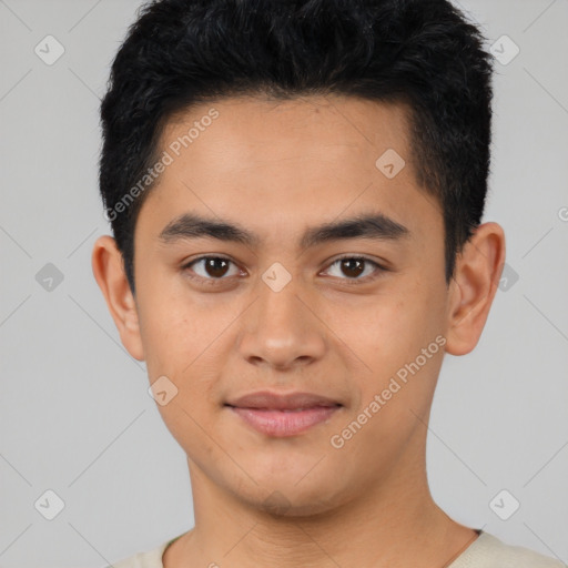 Joyful latino young-adult male with short  black hair and brown eyes