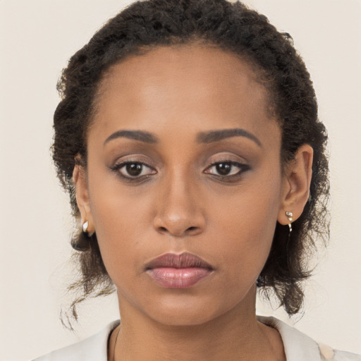 Neutral black young-adult female with long  brown hair and brown eyes