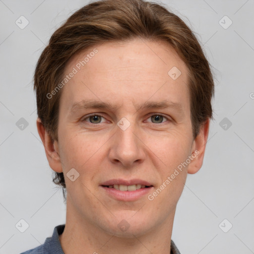 Joyful white adult male with short  brown hair and grey eyes