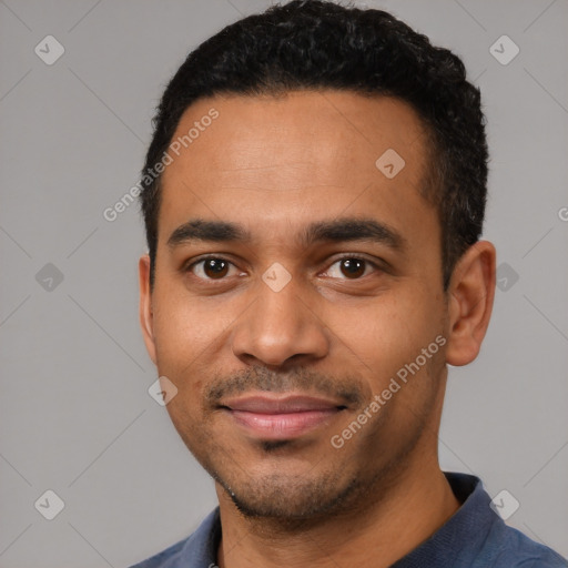 Joyful latino young-adult male with short  black hair and brown eyes