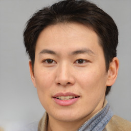 Joyful asian young-adult male with short  brown hair and brown eyes