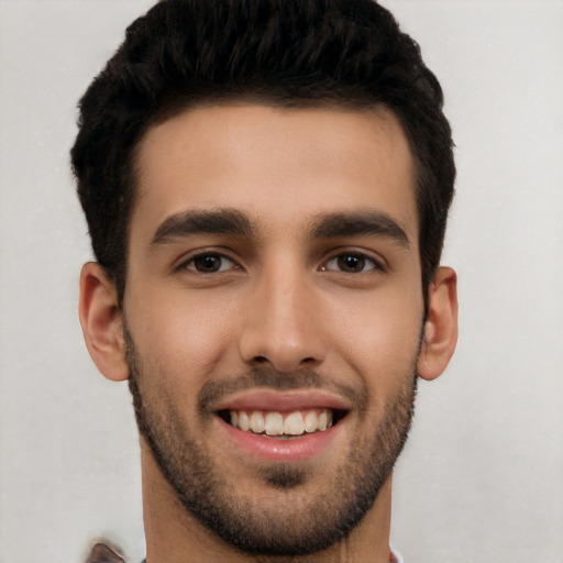 Joyful white young-adult male with short  black hair and brown eyes