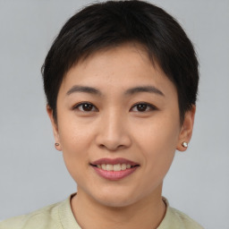 Joyful asian young-adult female with short  brown hair and brown eyes