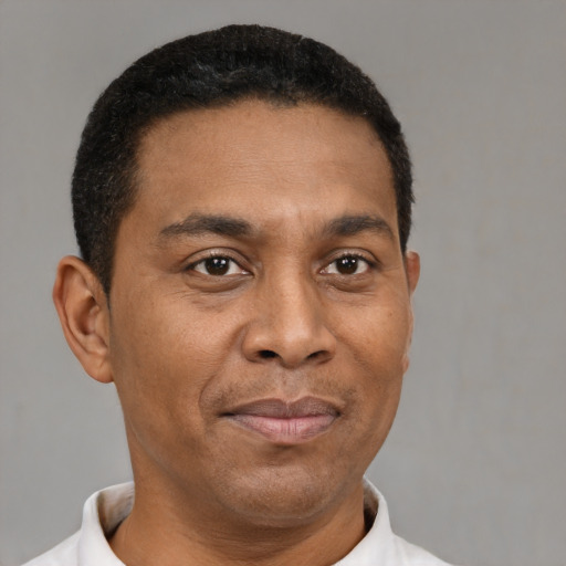 Joyful latino adult male with short  brown hair and brown eyes
