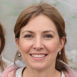 Joyful white young-adult female with medium  brown hair and blue eyes