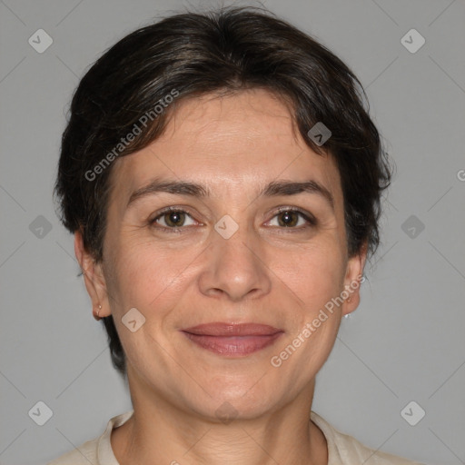 Joyful white adult female with medium  brown hair and brown eyes