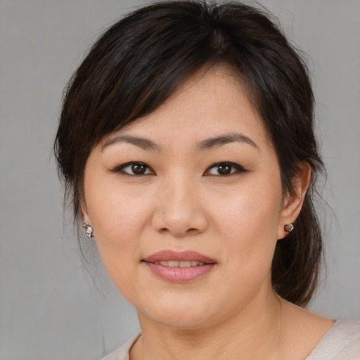 Joyful asian young-adult female with medium  brown hair and brown eyes