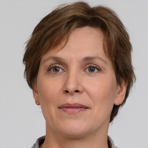 Joyful white adult female with medium  brown hair and grey eyes