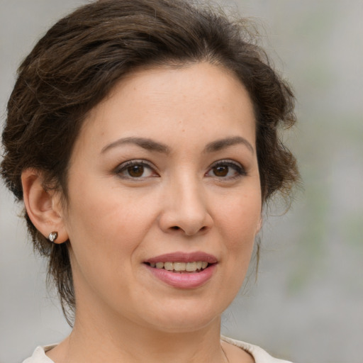 Joyful white adult female with medium  brown hair and brown eyes