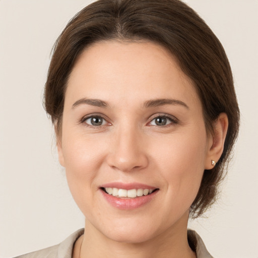 Joyful white young-adult female with medium  brown hair and brown eyes