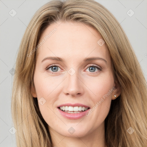 Joyful white young-adult female with long  brown hair and green eyes