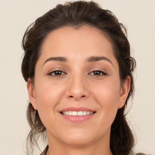 Joyful white young-adult female with medium  brown hair and brown eyes