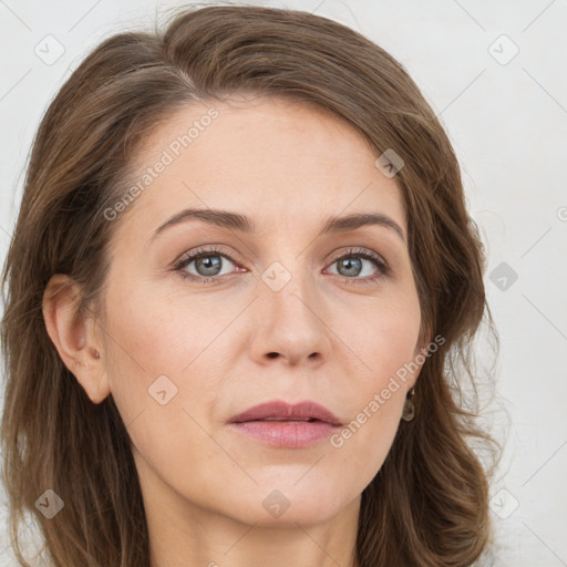 Joyful white young-adult female with long  brown hair and green eyes