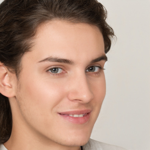 Joyful white young-adult male with medium  brown hair and brown eyes