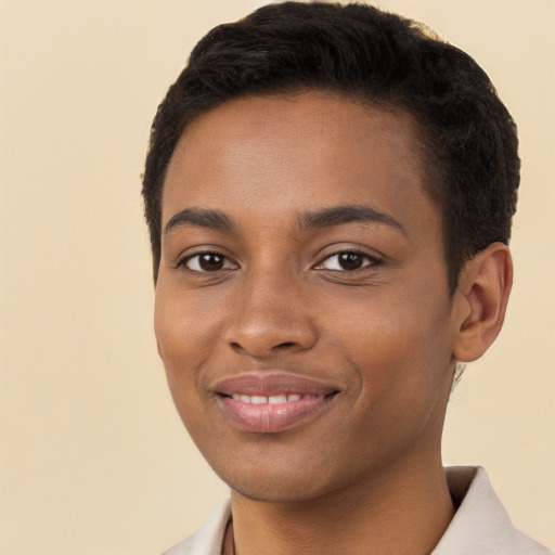 Joyful black young-adult female with short  brown hair and brown eyes