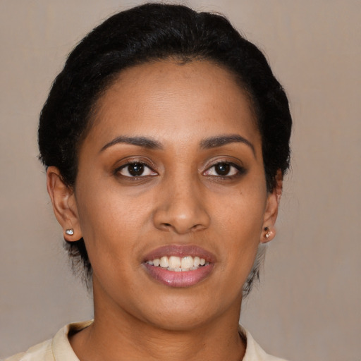 Joyful black young-adult female with short  brown hair and brown eyes