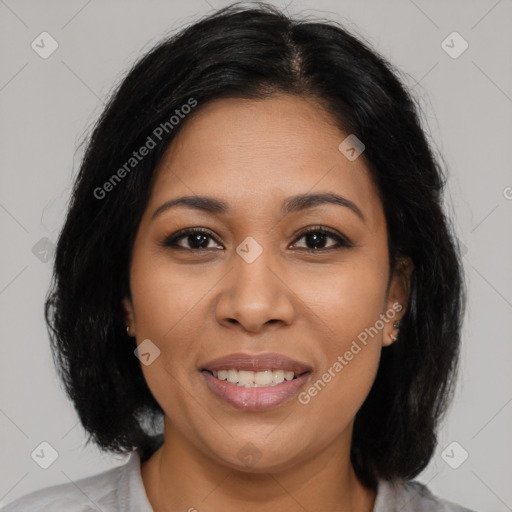 Joyful latino young-adult female with medium  brown hair and brown eyes