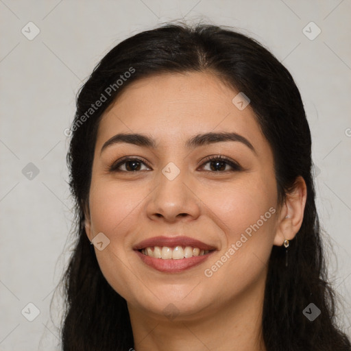 Joyful latino young-adult female with long  brown hair and brown eyes