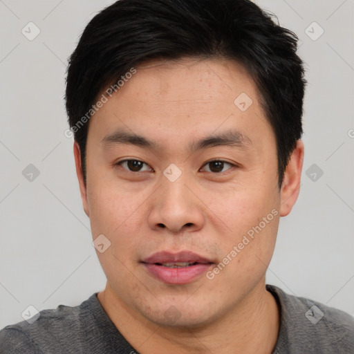 Joyful asian young-adult male with short  black hair and brown eyes