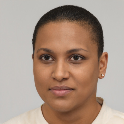 Joyful black young-adult female with short  black hair and brown eyes