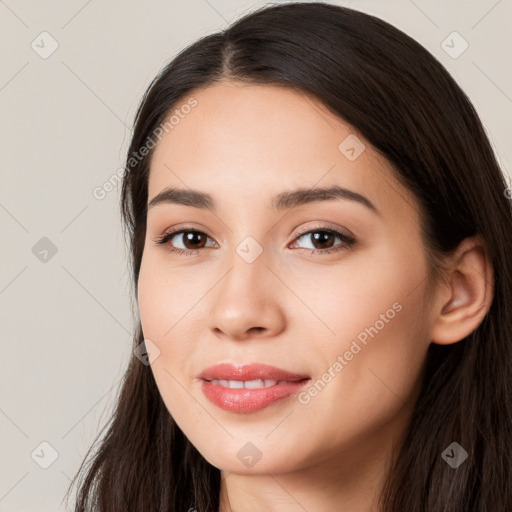 Joyful white young-adult female with long  brown hair and brown eyes