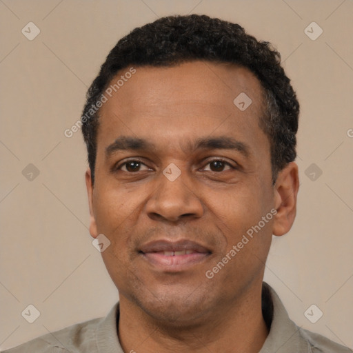 Joyful latino adult male with short  black hair and brown eyes