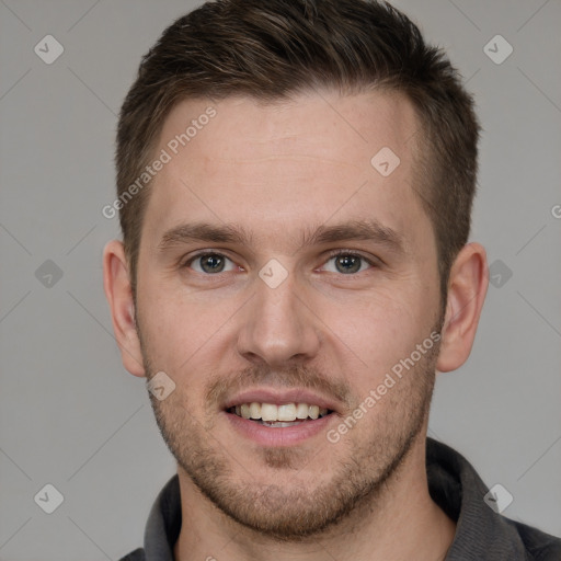 Joyful white young-adult male with short  brown hair and grey eyes