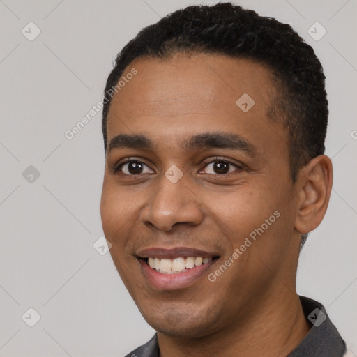 Joyful black young-adult male with short  black hair and brown eyes