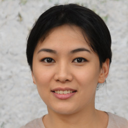 Joyful asian young-adult female with medium  black hair and brown eyes
