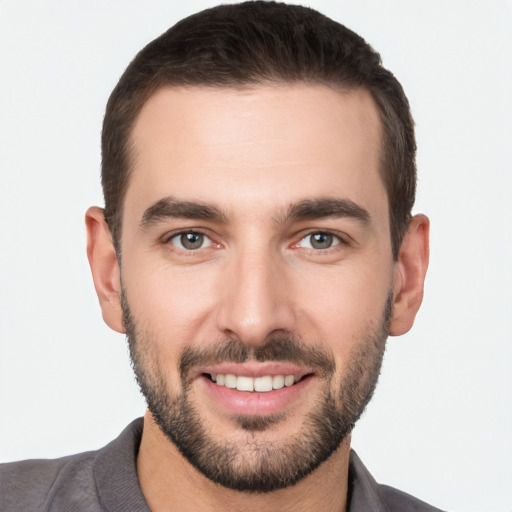 Joyful white young-adult male with short  black hair and brown eyes