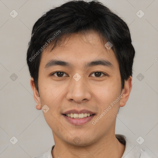 Joyful asian young-adult male with short  brown hair and brown eyes