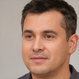 Joyful white adult male with short  brown hair and brown eyes