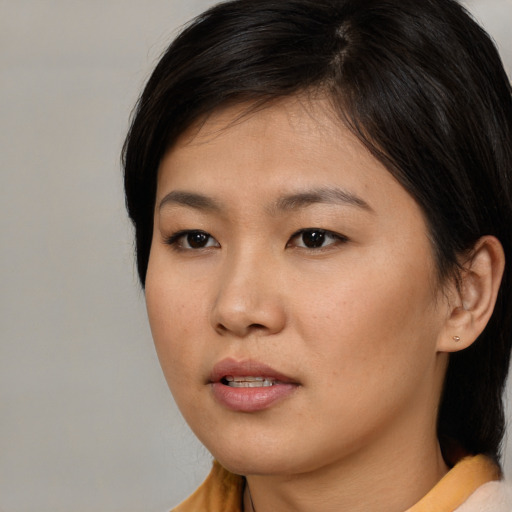 Neutral asian young-adult female with medium  brown hair and brown eyes