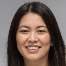 Joyful white young-adult female with long  brown hair and brown eyes