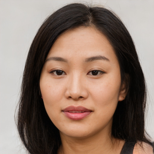 Joyful asian young-adult female with long  brown hair and brown eyes