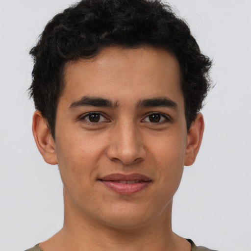 Joyful latino young-adult male with short  brown hair and brown eyes