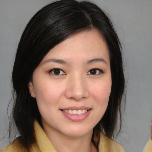 Joyful asian young-adult female with medium  brown hair and brown eyes