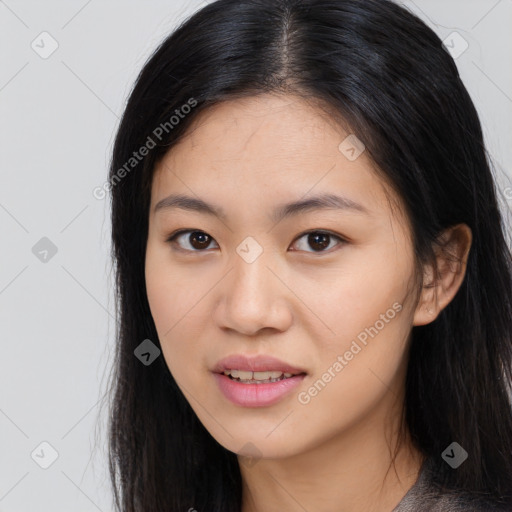 Joyful asian young-adult female with long  black hair and brown eyes