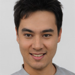 Joyful asian young-adult male with short  brown hair and brown eyes