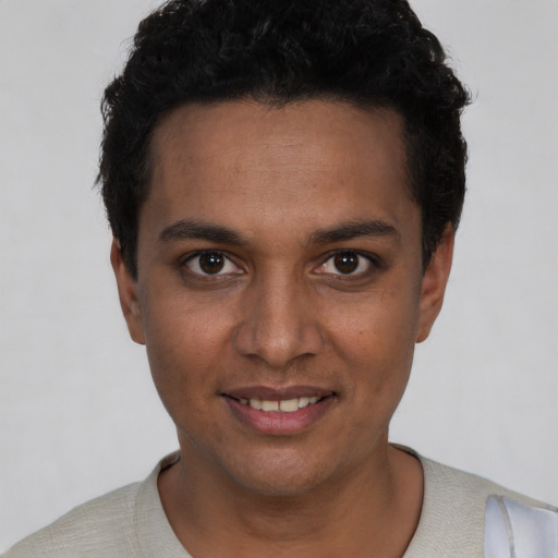 Joyful white young-adult male with short  black hair and brown eyes